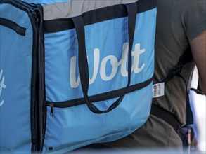 Bicycle courier with light blue bag from Wolt delivery service, Frankfurt am Main, Hesse, Germany,