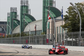 BENJAMIN PEDERSEN (R) (55) of Copenhagen, Denmark runs through the streets during the Honda Indy