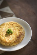 Spanish tortilla traditional omelet on rustic florr tiles