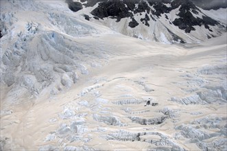 Franz Josef Glacier, Westland, New Zealand. Brown discolouration on the snow is smoke from