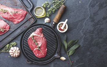 Food, Fresh raw meat. Beef Tenderloin and marbled beef steaks on grill pan and frying board with