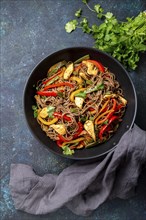 Japanese dish buckwheat soba noodles with chicken and vegetables carrot, bell pepper and green