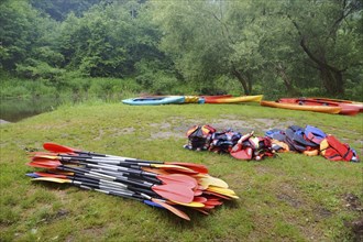 The oars from the canoes on the shore, preparing for the Canoeing