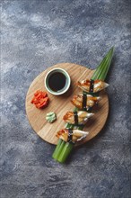 Sashimi sushi set on wooden board. Stone background. Top view