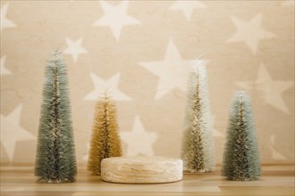 Wooden podium pedestal product mockup display with miniature Christmas trees in beige and green, 3d