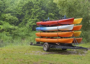 On the trailer with eight canoes, kayaks by car delivered to the river