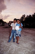 Maldivian children with football, Maldives, Indian Ocean, Meemu Atoll, Asia