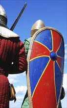 Group of knights with helmets, shields and armors