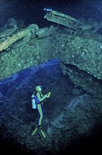 Diver and vehicle wreck in the Blue Belt shipwreck, Sudan, Africa, Red Sea, Sha'ab Su'adi, Africa