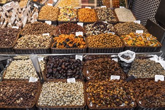 Dried fruits and nuts deli stall display at la boqueria market in barcelona spain