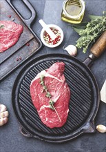 Food, Fresh raw meat. Beef Tenderloin and marbled beef steaks on grill pan and frying board with