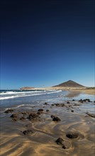 La tejita kite surfing beach and montana roja landmark in south tenerife spain