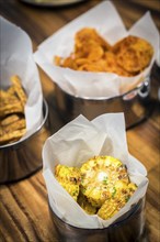 Rustic grilled sweetcorn and other simple snack food on table