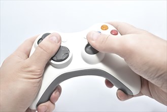 Joystick gamepad in the player's hands isolated on white background