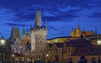 Blue hour view of illuminated landmark Lesser Town Charles Bridge gothic tower and historic