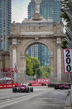 HELIO CASTRONEVES (06) of Sao Paulo, Brazil runs through the streets during the Honda Indy Toronto