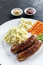 German sausage with mashed potato and vegetables simple meal