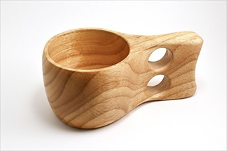 Traditional finnish wooden kuksa cup on white background, wood cup traditional used by the Saami