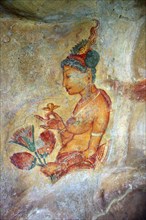 SIGIRIYA, SRI LANKA, MARCH 20, 2015: Sigiriya maiden, 5th century frescoes at the ancient rock