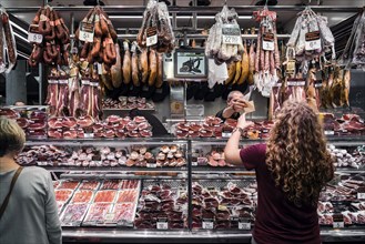 Traditional cured meat and sausage shop in la boqueria market of barcelona spain