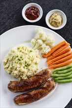 German sausage with mashed potato and vegetables simple meal