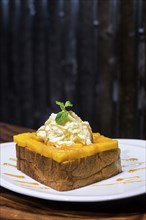 Gourmet fusion french toast with mango and whipped cream