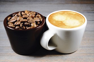 Espresso and cup of coffee beans on wood