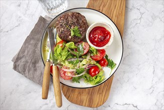 Food Photography, Beef hamburger with lettuce tomato salad on white plate, top view