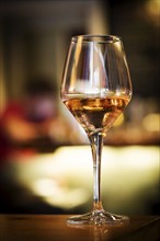 Glass of rose wine on bar counter at night