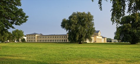 World Heritage Residence Ensemble Schwerin: Stables, surrounded by green lawns and trees under a