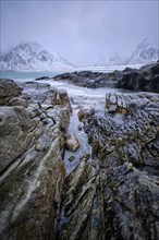 Waves and rocks on coast of Norwegian sea in fjord. Skagsanden beach, Flakstad, Lofoten islands,