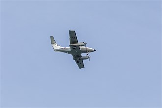 Twin-engine naval aircraft flies over beach, Westende, Middelkerke, Belgium, Europe