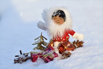 Christmas decoration, Inuit with Christmas presents in the snow