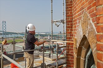 Detroit, Michigan, Kevin Driscoll cleans the bell towers of the Basilica of Ste. Anne de Detroit.