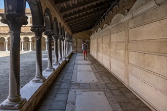 Young man in the cloister with graves, church Chiesa di San Michele in Isola, cemetery island San