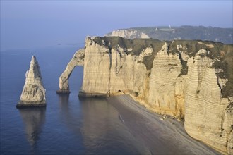 L'Aiguille and the Porte D'Aval, a natural arch in the chalk cliffs at Etretat, Côte d'Albâtre,