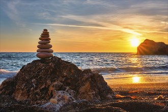 Concept of balance and harmony. Cairn stack of stones pebbles cairn on the beach coast of the sea