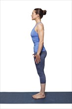 Woman doing Hatha Yoga asana Tadasana, Mountain pose with stretched hands isolated