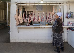 Woman at the market stall for meat products, Uzgen Bazaar, Ösgön, Osh region, Kyrgyzstan, Asia