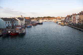 Colourful fishing boats in the harbour at Weymouth, Dorset, England, UK