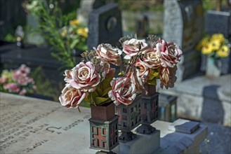 Faded plastic roses on a grave in the Staglieno Monumental Cemetery, Cimitero Monumentale di