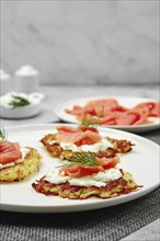 Closeup view of potato flapjacks with salmon and cream cheese