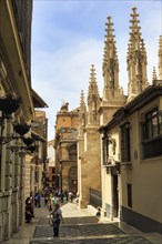 Tourists, strollers in the old town, towers of the cathedral Santa Maria de la Encarnacion de