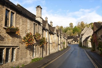 A row of attractive stone cottages in Castle Combe, Wiltshire, England, UK claimed to be England's