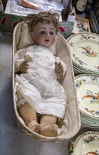 Vintage doll on display at auction room, UK