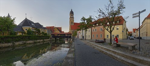 Panorama of the river Vils with the spire of St Martin's Basilica and the historic ship bridge at