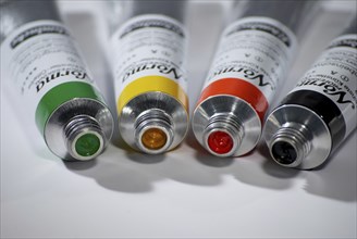 Four paint tubes, artist colours, green, yellow, red, black