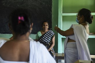 Beneficiaries receives dose of COVID-19 coronavirus vaccine in a vaccination centre at a village in