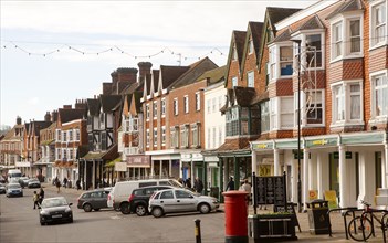 People shopping on historic High Street of Marlborough, Wiltshire, England, UK