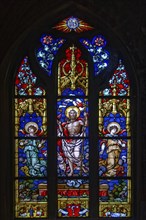 A colourful stained glass window with Christian motifs in the Basilica of St. Martin, Amberg, Upper